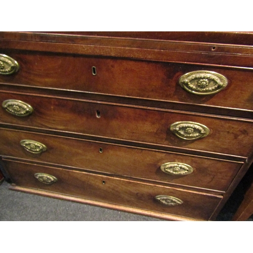 1064 - A George III mahogany straight front chest of four long graduated drawers with brushing slide.  Feet... 