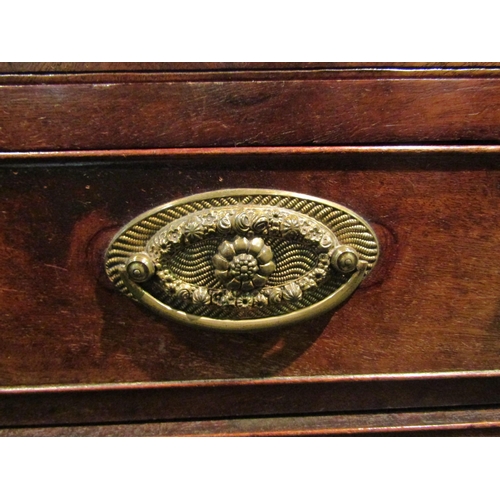 1064 - A George III mahogany straight front chest of four long graduated drawers with brushing slide.  Feet... 