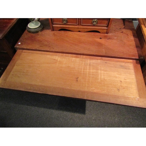 1064 - A George III mahogany straight front chest of four long graduated drawers with brushing slide.  Feet... 