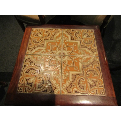 1076 - A G-Plan nest of three teak tables with tiled top to largest