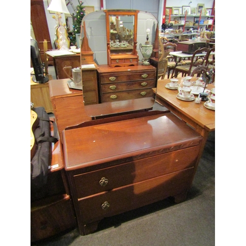 1107 - A 1940's oak chest of four drawers together with a matching dressing chest with raised mirror back (... 