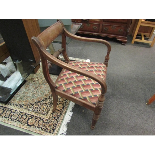 1149 - An elbow chair on turned fore legs with rope twist back