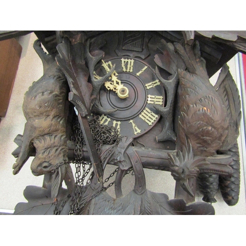 1158 - A Black Forest cuckoo clock with deer and game detail, A/F