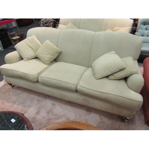 1176 - A three seater sofa with matching cushions, seat cushion a/f