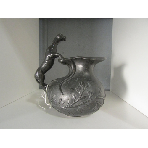 1285 - A bronze jug with dog handle and scrolling foliage, 18cm high