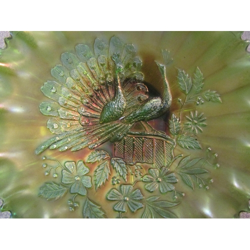 1299 - A carnival glass dish decorated with central peacocks, 22cm diameter