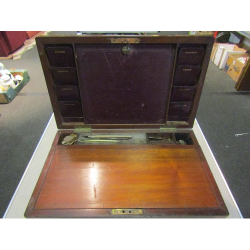 1324 - A mahogany and brass banded stationery box with letter slots, inkwell and tooled leather interior