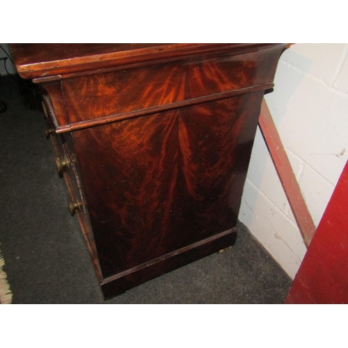 1004 - A 19th Century flame mahogany writing commode. The top drawer pulls out to reveal central writing su... 