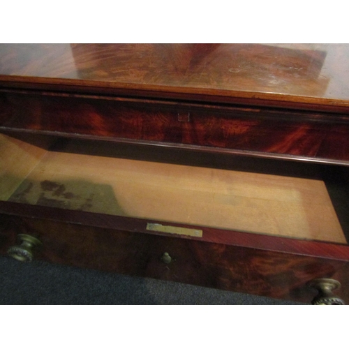 1004 - A 19th Century flame mahogany writing commode. The top drawer pulls out to reveal central writing su... 