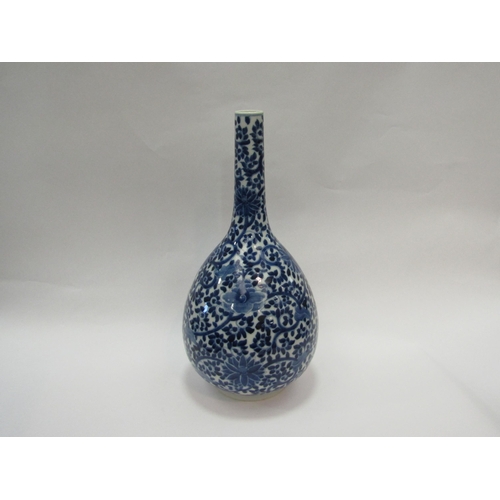 1542 - A 19th Century Chinese bottle vase with all-over floral detailing, 39cm high