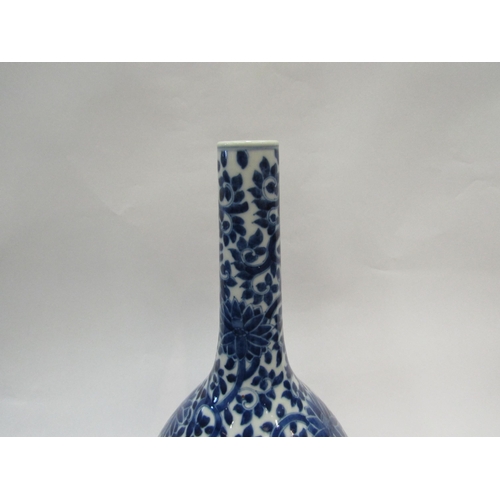 1542 - A 19th Century Chinese bottle vase with all-over floral detailing, 39cm high