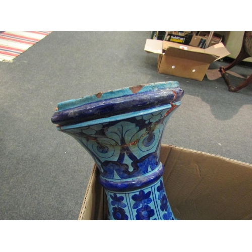 1563 - A Persian terracotta blue glazed vase with floral design, very badly damaged    (E)  £10-20