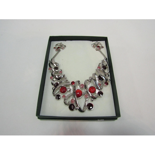 1336 - A costume necklace and matching clip earrings, boxed