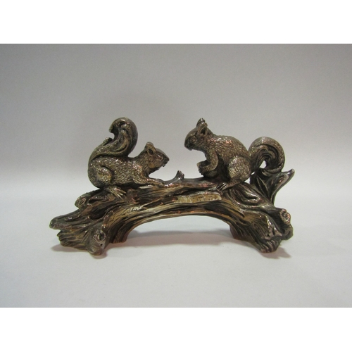 1372 - A silver covered figural group of two squirrels on a log, stamped 925, 9cm high x 18cm long