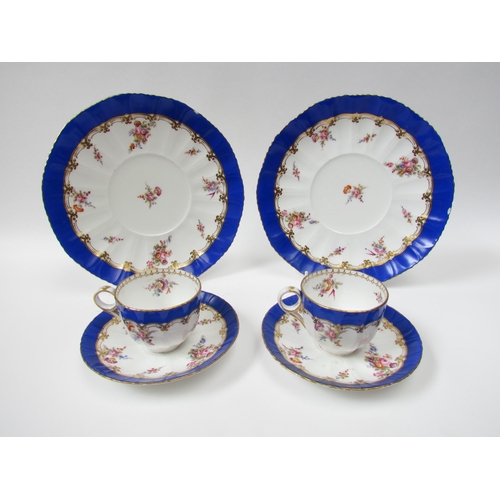 4008 - A 19th Century porcelain part tea service with handpainted floral sprays, bright blue border, cups w... 