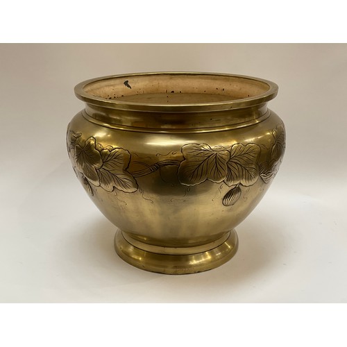 4012 - A large brass oriental jardinière with bird and leaf decoration having a painted interior, 29cm tall