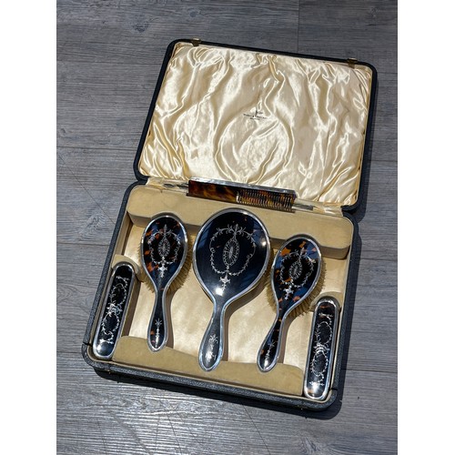 4016 - A Walker and Hall six piece tortoiseshell and silver dressing table set, comprising of hand mirror, ... 