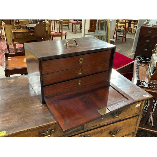 4017 - A George III mahogany three drawer cabinet with exposed dovetails the unusual brass semi-circular ha... 