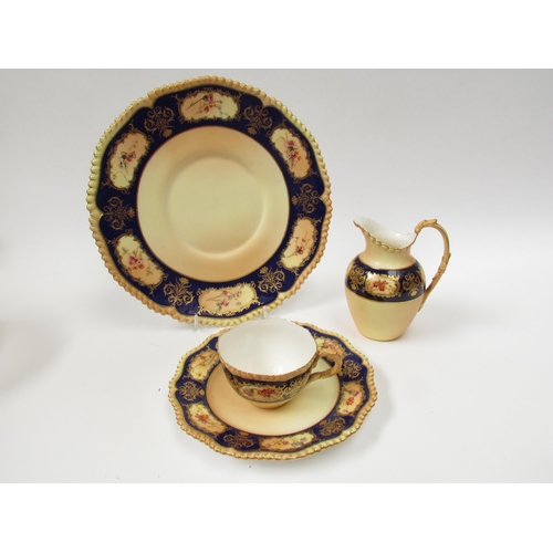 4079 - A 19th Century porcelain part tea service with hand painted floral sprays, bright blue border, cups ... 