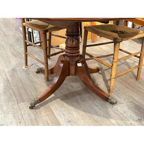 4080 - A 19th Century mahogany breakfast table, the circular top on turned column to quatreform base, 69cm ... 