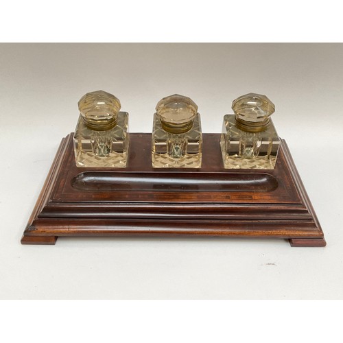 4103 - A 19th Century walnut deskstand with three substantial ink wells and pen tray, 37cm wide x 22cm deep... 