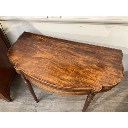 4133 - A George III serpentine mahogany tea table on turned legs, 73cm high x  91cm long x 47cm deep folded... 