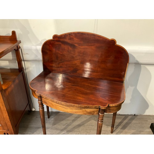 4133 - A George III serpentine mahogany tea table on turned legs, 73cm high x  91cm long x 47cm deep folded... 