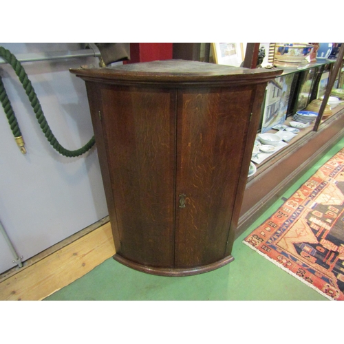 4147 - A George III oak and mahogany crossbanded North Country bow front two door wall hanging corner cupbo... 