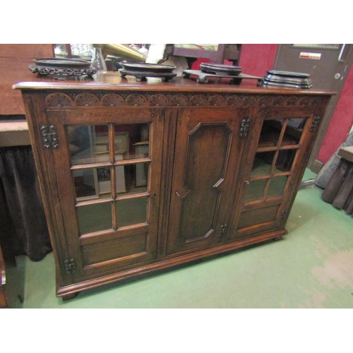 4232 - A Titchmarsh & Goodwin 17th Century revival carved and pegged oak bookcase of three doors (two panel... 