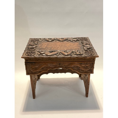 4242 - A Korean hardwood tabletop chest, the lift-up lid opening to reveal storage, over a shaped frieze, o... 