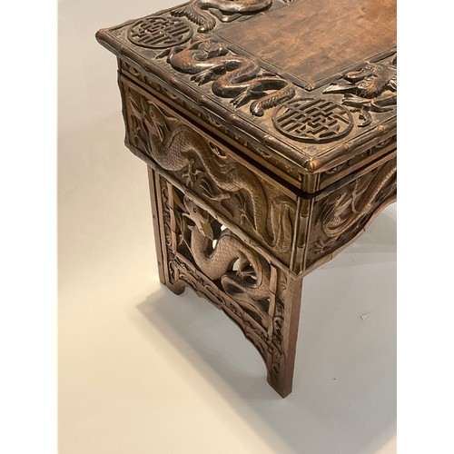 4242 - A Korean hardwood tabletop chest, the lift-up lid opening to reveal storage, over a shaped frieze, o... 