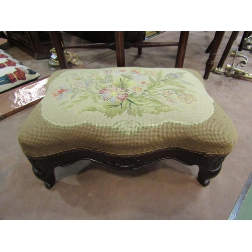 4254 - A 19th Century walnut serpentine side shaped stool the floral petit point upholstered seat over a ca... 