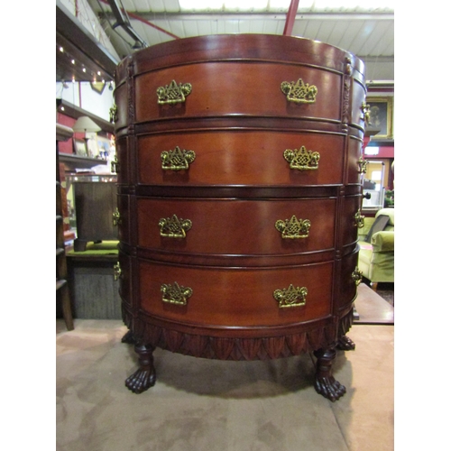 4255 - A Georgian style mahogany bow front chest, the sun ray veneered top over twelve drawers and carved l... 