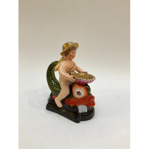 4286 - An unusual late 18th / early 19th Century figural chamber stick as a putto in a hat seated astride a... 