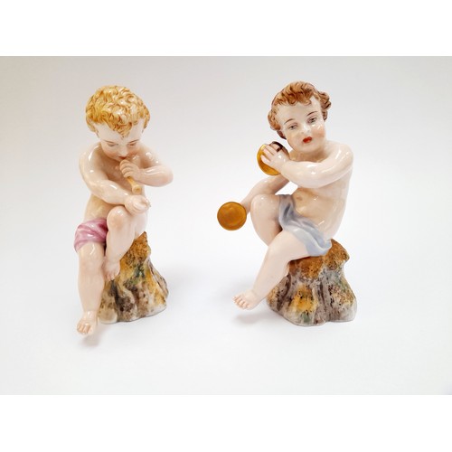 4296 - A Royal Worcester figure of a putto playing a horn. Hand a/f. A matching cymbal-playing putto, cymba... 