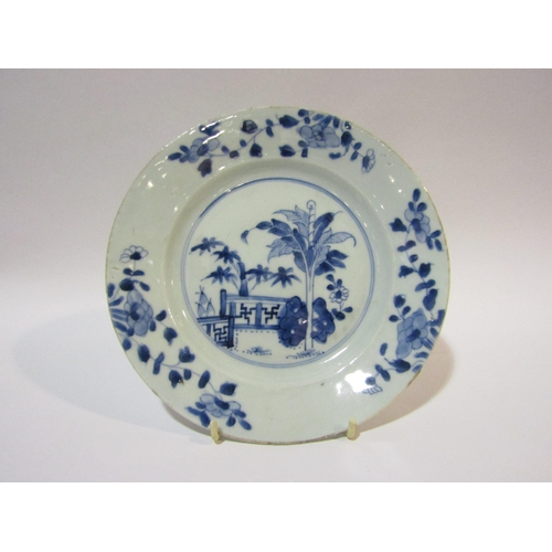 4301 - A Chinese blue and white plate decorated with floral rim and central landscape, 23cm diameter