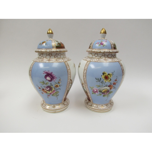 4310 - A pair of 19th Century Dresden lidded urns with handpainted cartouches, floral spray detail, 27cm ta... 