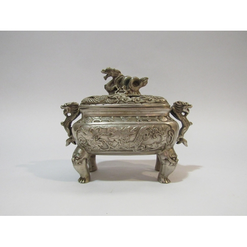 4325 - A Chinese white metal censer and cover having dragon decoration with six character mark to base, app... 