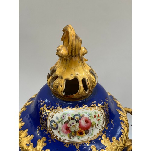 4170 - A pair of Rockingham porcelain lidded urns, blue ground with floral panels, enriched with gilt, heav... 