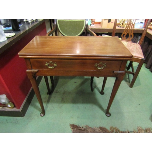 4001 - A George II mahogany side table with fold-over hinged top the single frieze drawer on lappet carved ... 