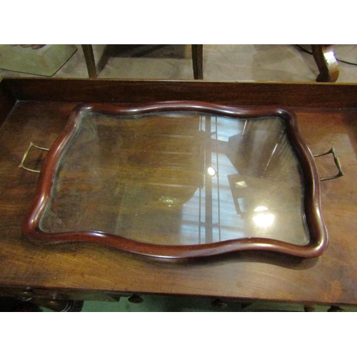 4005 - A mahogany twin handled shaped tray with glass interior, parquetry border, 69cm long    (R)  £25