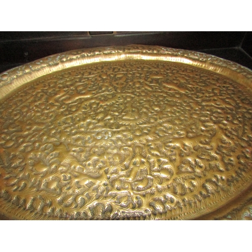 4033 - A circa early 20th Century hammered brass repousse work tray, with another similar (2)   (R)  £10