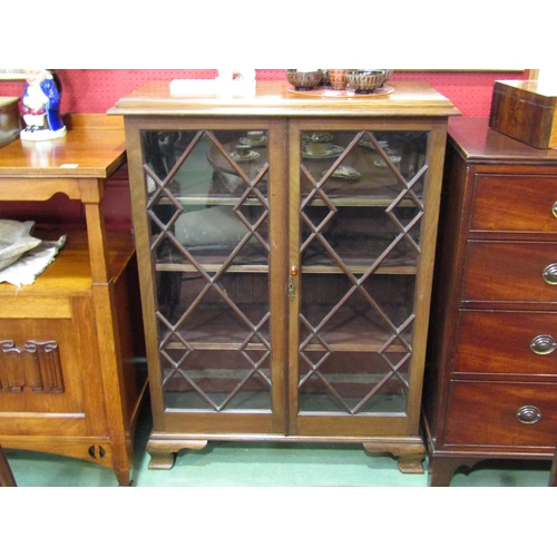 4049 - A Victorian mahogany astragal glazed two door bookcase with height adjustable shelves over ogee brac... 