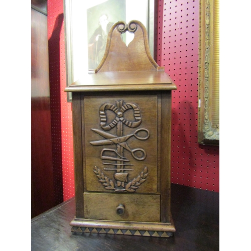 4059 - A 19th Century walnut hinged lid candle box with fret handle over a carved sewing accoutrement panel... 