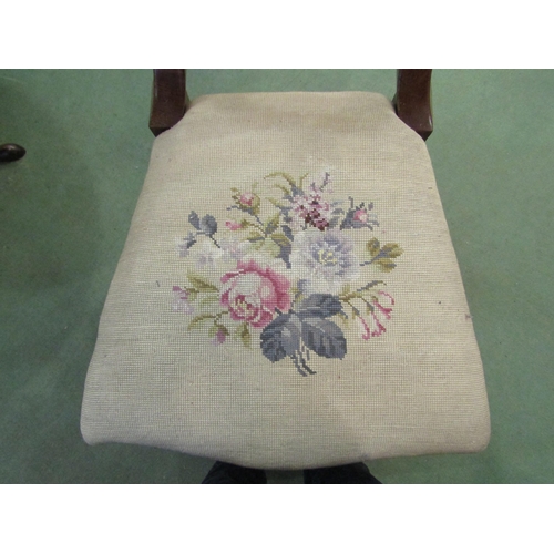 4090 - A mahogany carved chair the needlepoint floral serpentine front seat over carved and turned tapering... 