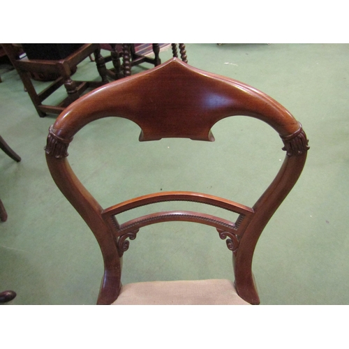 4090 - A mahogany carved chair the needlepoint floral serpentine front seat over carved and turned tapering... 