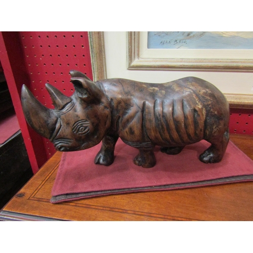 4096 - An Eastern hardwood carved figure of a rhinoceros, 15cm high