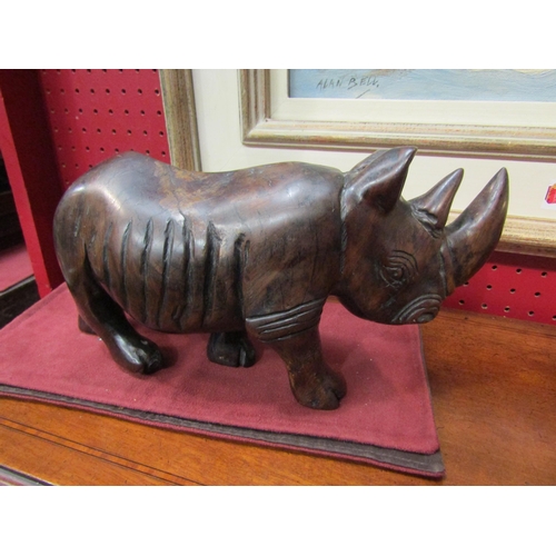 4096 - An Eastern hardwood carved figure of a rhinoceros, 15cm high