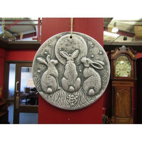 4120 - A terracotta wall plaque of three hares gazing at the moon, 19.5cm diameter   (E)  £20-30