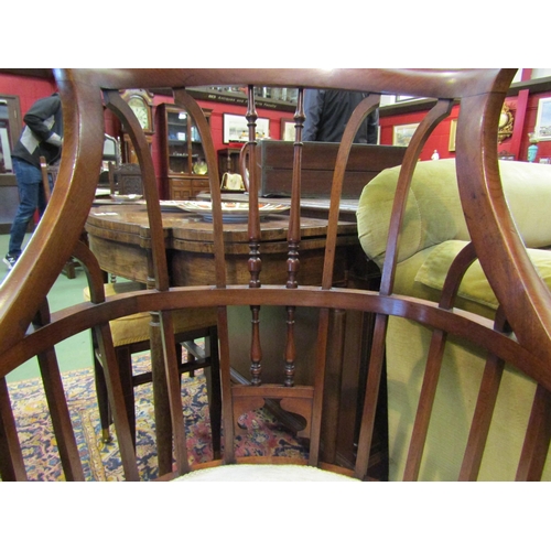 4135 - An Arts & Crafts walnut open armchair in the manner of Jas. Shoolbred with spindle backrest the serp... 